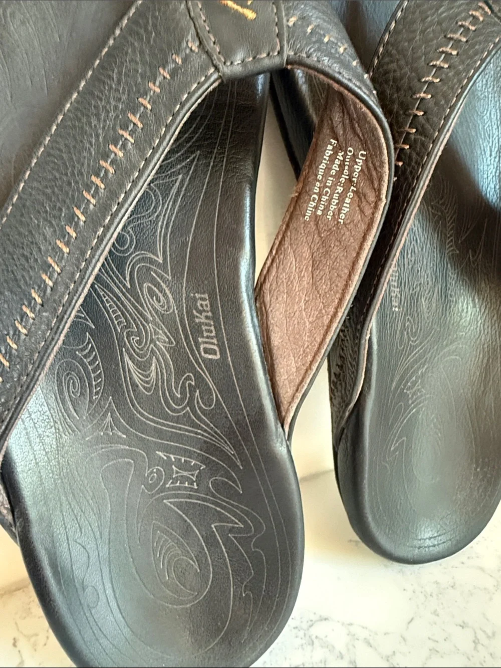 OluKai Men's Hiapo Leather flip-flops Sandals Black Whipstitching Moko Tattoo